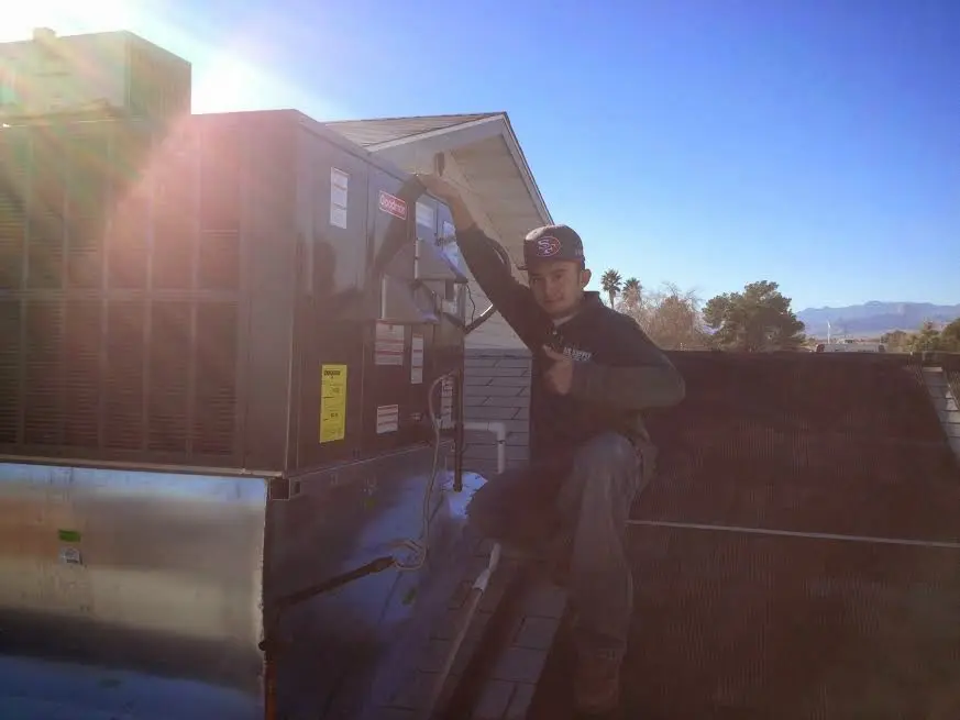 HVAC technician performing HVAC Inspection on a rooftop unit in Duarte